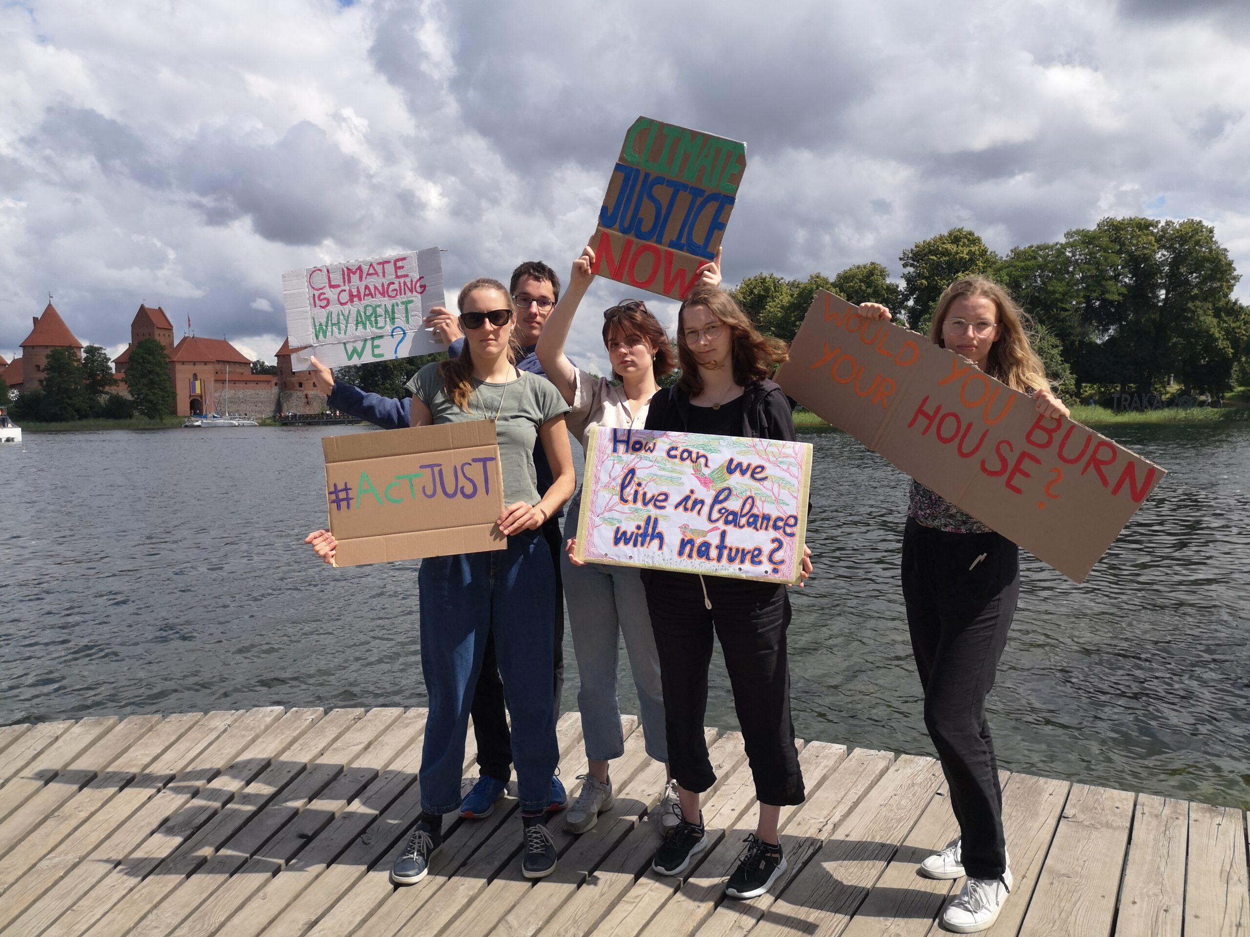 young people holding up sign for climate justice